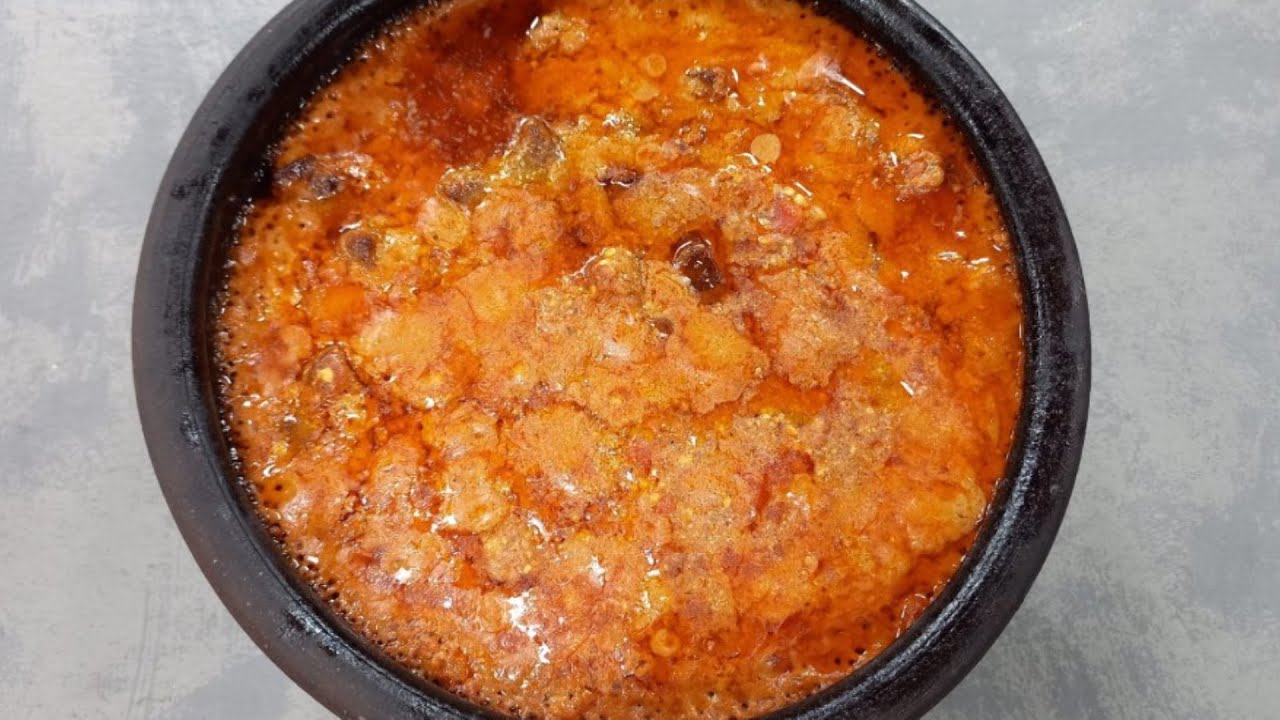 Oven-baked beef meatballs in a clay pot with tomatoes and spices