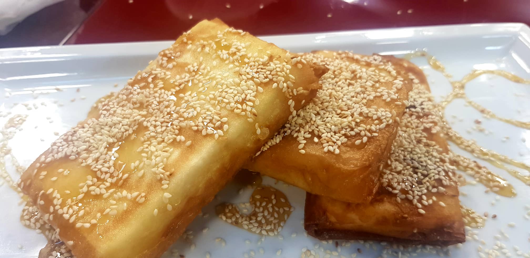 Oven-baked kaçkavall cheese with honey and sesame seeds